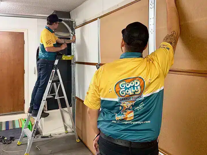 Good Golly Garage Doors techs measuring garage door in residential home in Las Vegas, NV.