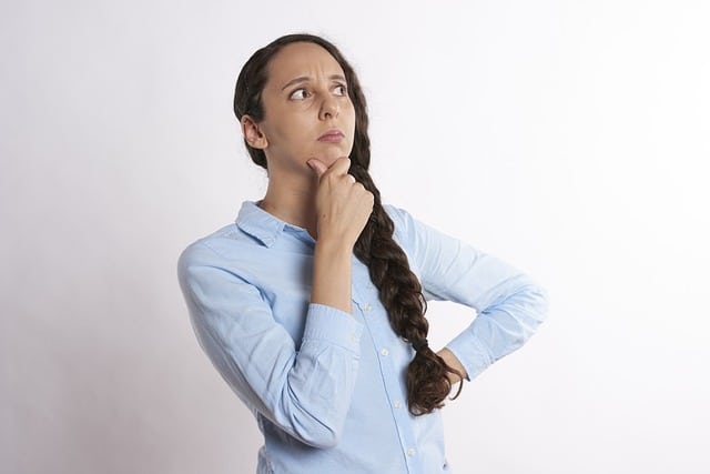 woman thinking and trying to decide between garage door repair and garage door replacement in Austin